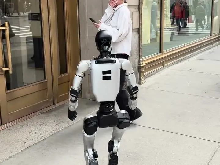 Bart, a humanoid robot, walking down a sidewalk